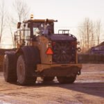 Hughes Trucking equipment and hauling services on site.