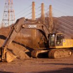 Hughes Trucking equipment and hauling services on site.