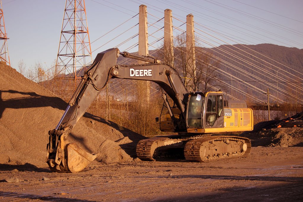 Hughes Trucking equipment and hauling services on site.