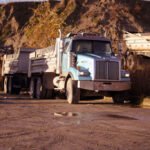 Hughes Trucking equipment and hauling services on site.